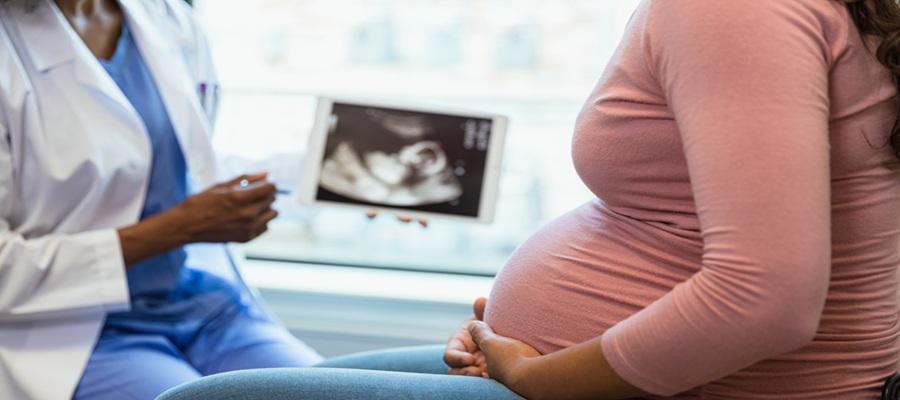 Expectant mother meets with doctor to review ultrasound.